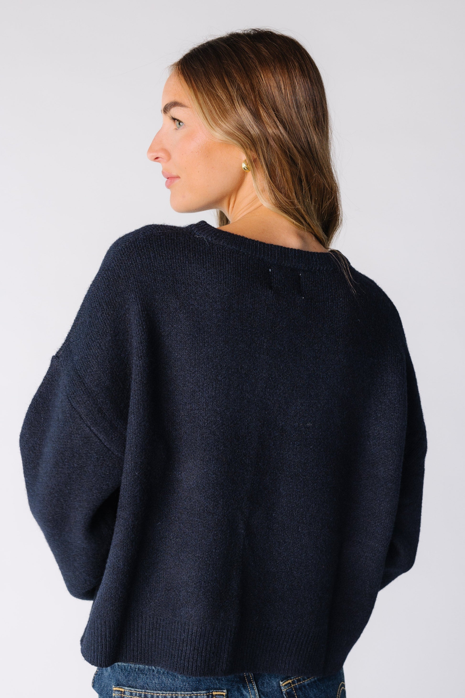 Back view of a woman wearing a navy cardigan