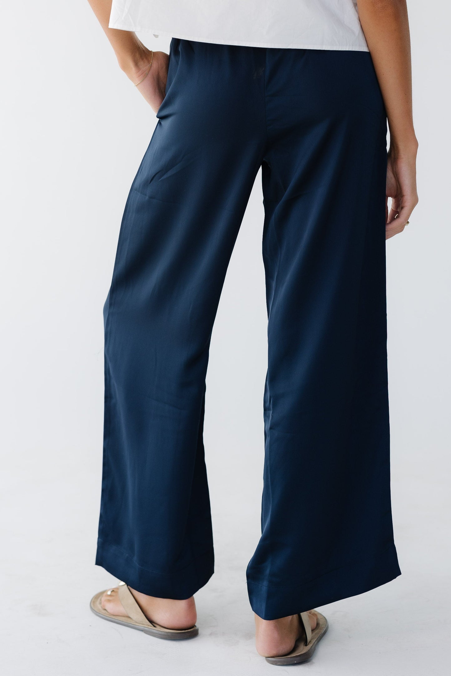 Woman wearing navy wide leg pants.