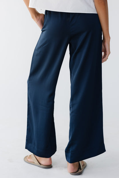 Woman wearing navy wide leg pants.