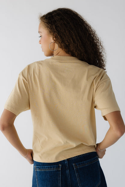 Back view of a teenage girl wearing a yellow short sleeve tee.