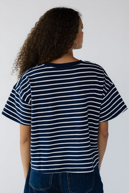 Back view of a woman wearing a navy & white stripe short sleeve tee. 