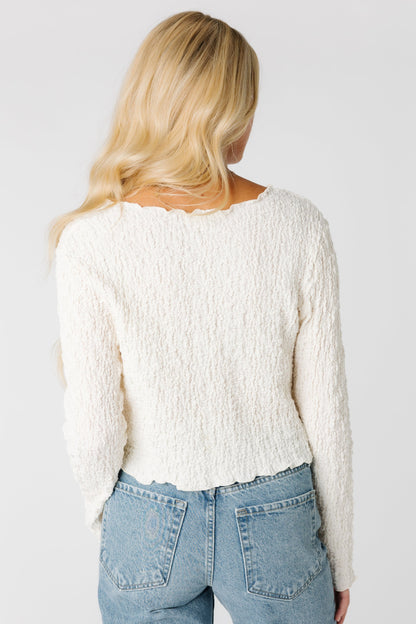 Back view of ivory textured long sleeve top