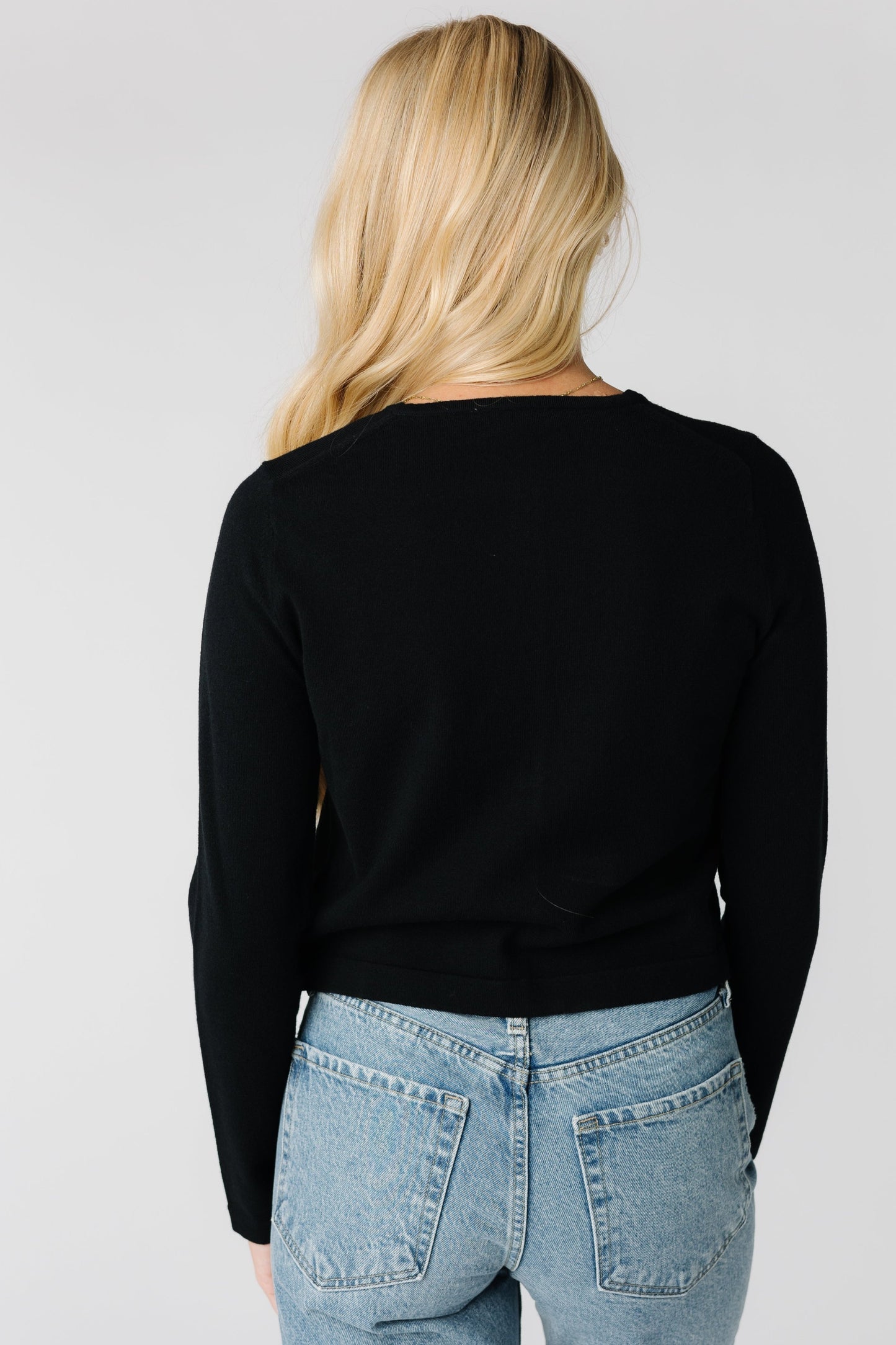 Back view of basic black long sleeve cardigan