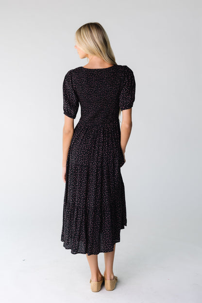 Back view of a black print dress with short sleeves