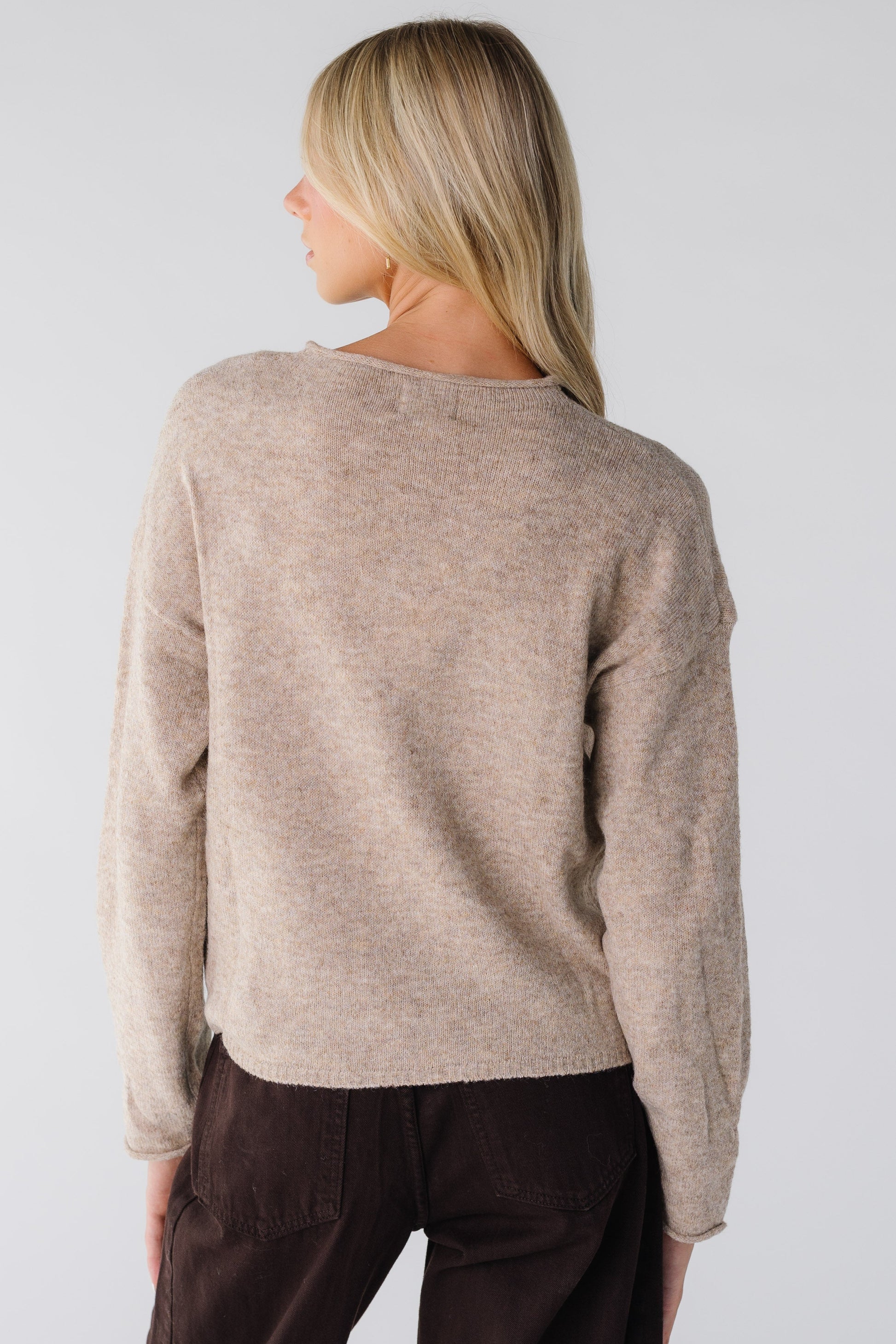 Back view of a woman wearing a mocha long sleeve sweater