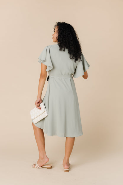 Back view of dusty sage dress wtih flutter sleeves