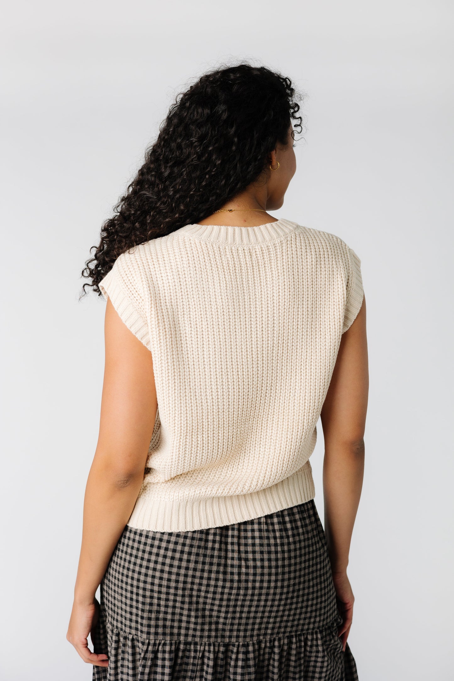 Back view of off white sweater vest