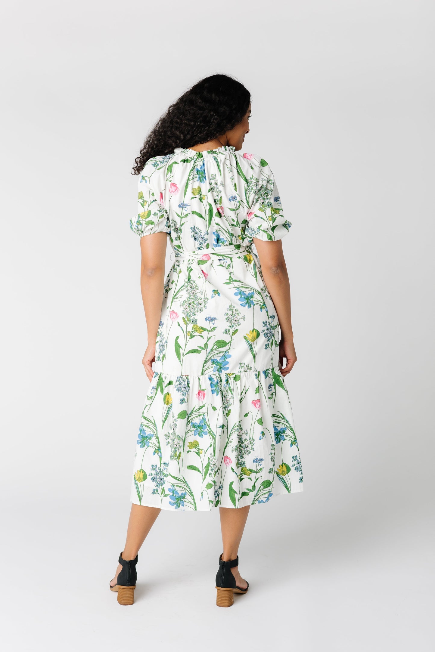 Back view of white dress with floral print and short sleeves