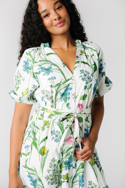 Close up view of  button down floral print dress with v-neckline