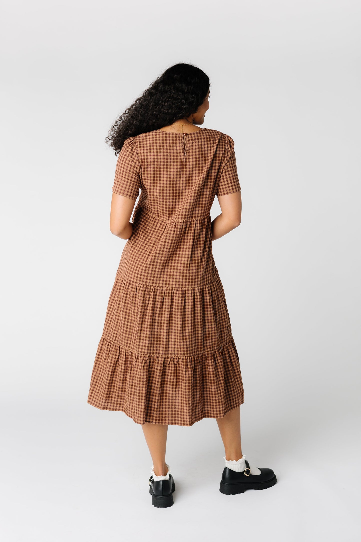 Back view of brown gingham midi dress with short sleeves