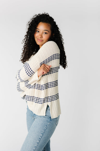 Off white sweater with blue stripes and short side slits