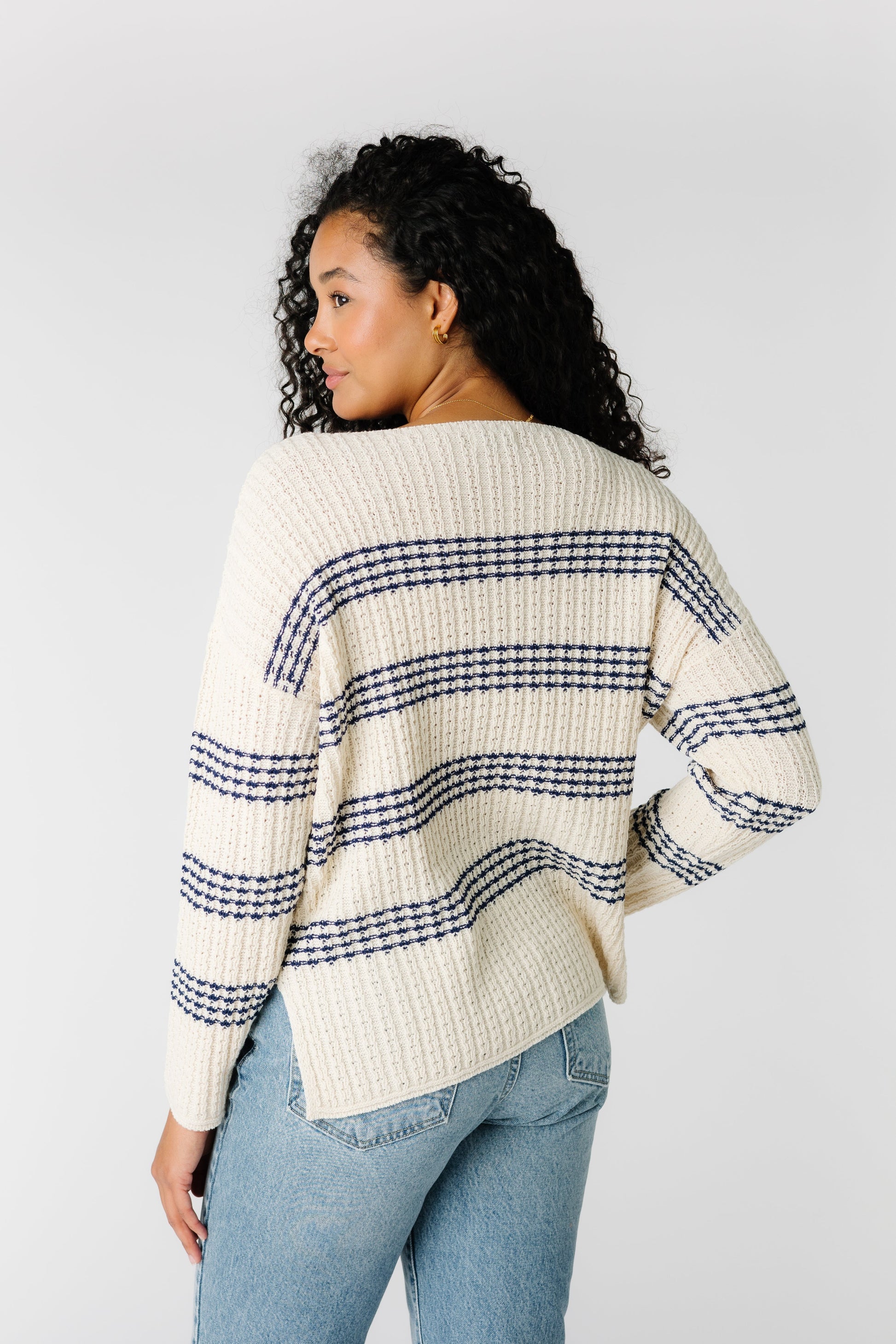 Back view of off white ribbed sweater