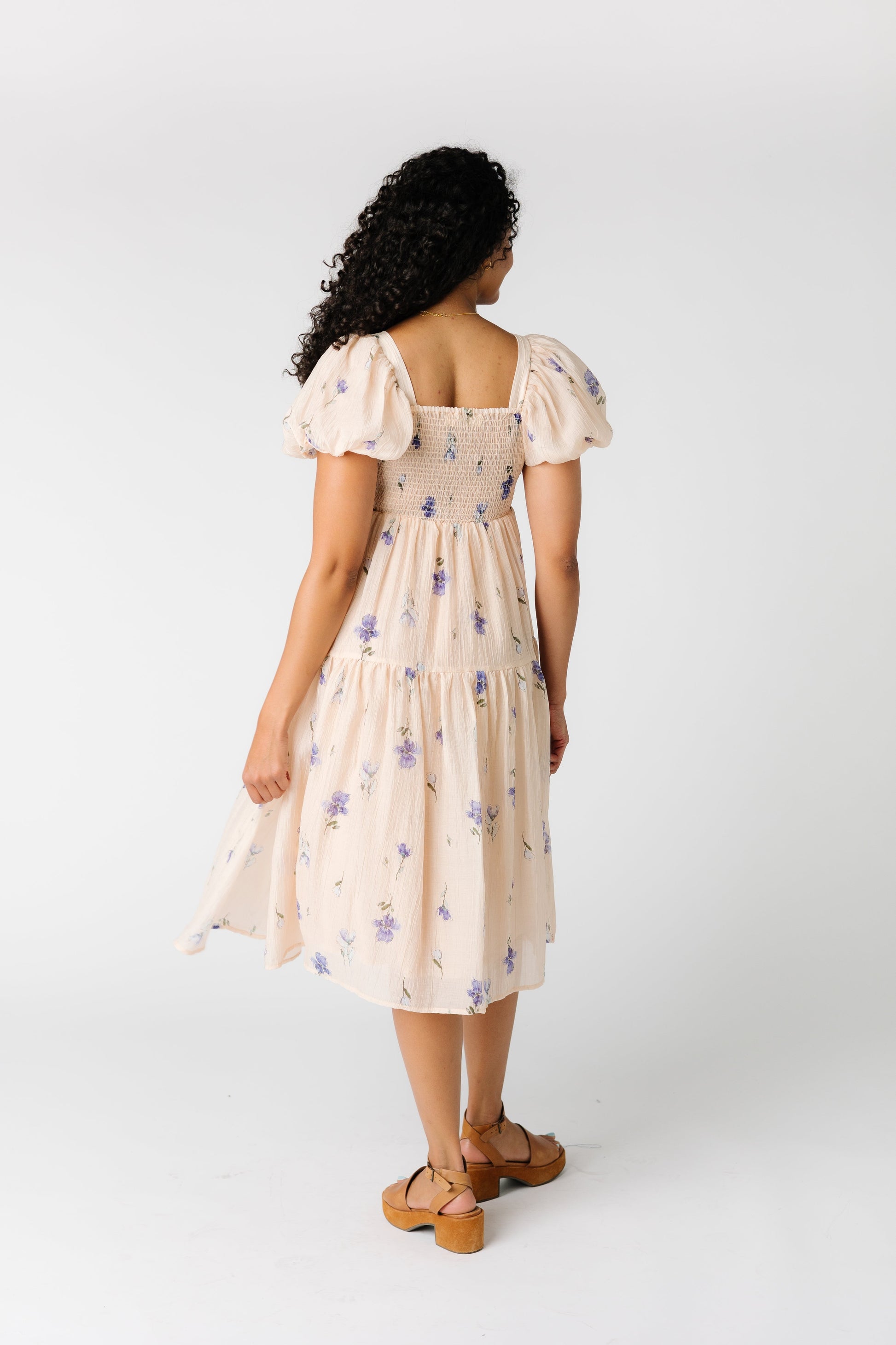 Back view of peach dress with lavender floral print with smocked back bodice and square neckline