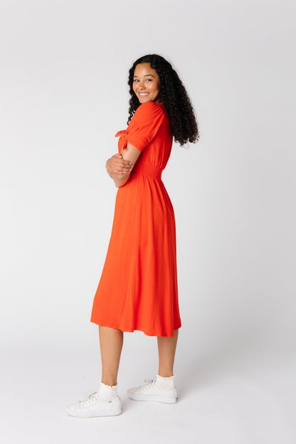 Distant side view of red midi dress with short sleeves