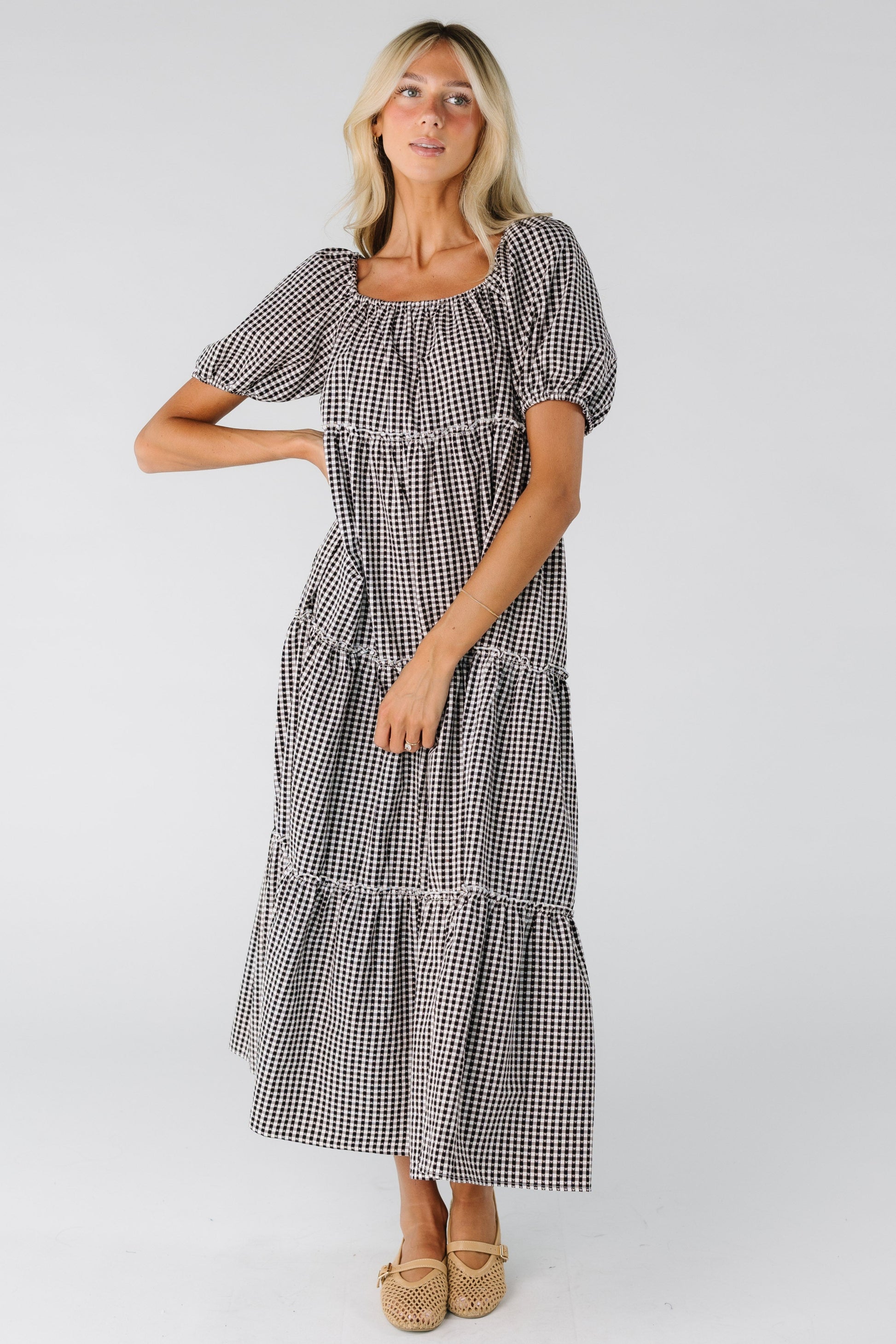 Woman wearing a black and white gingham tiered dress
