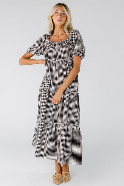 Woman wearing a black and white gingham tiered dress
