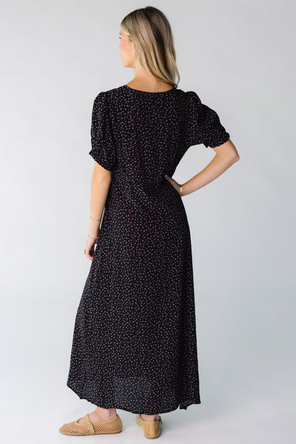 Back view of a woman wearing a black print midi dress