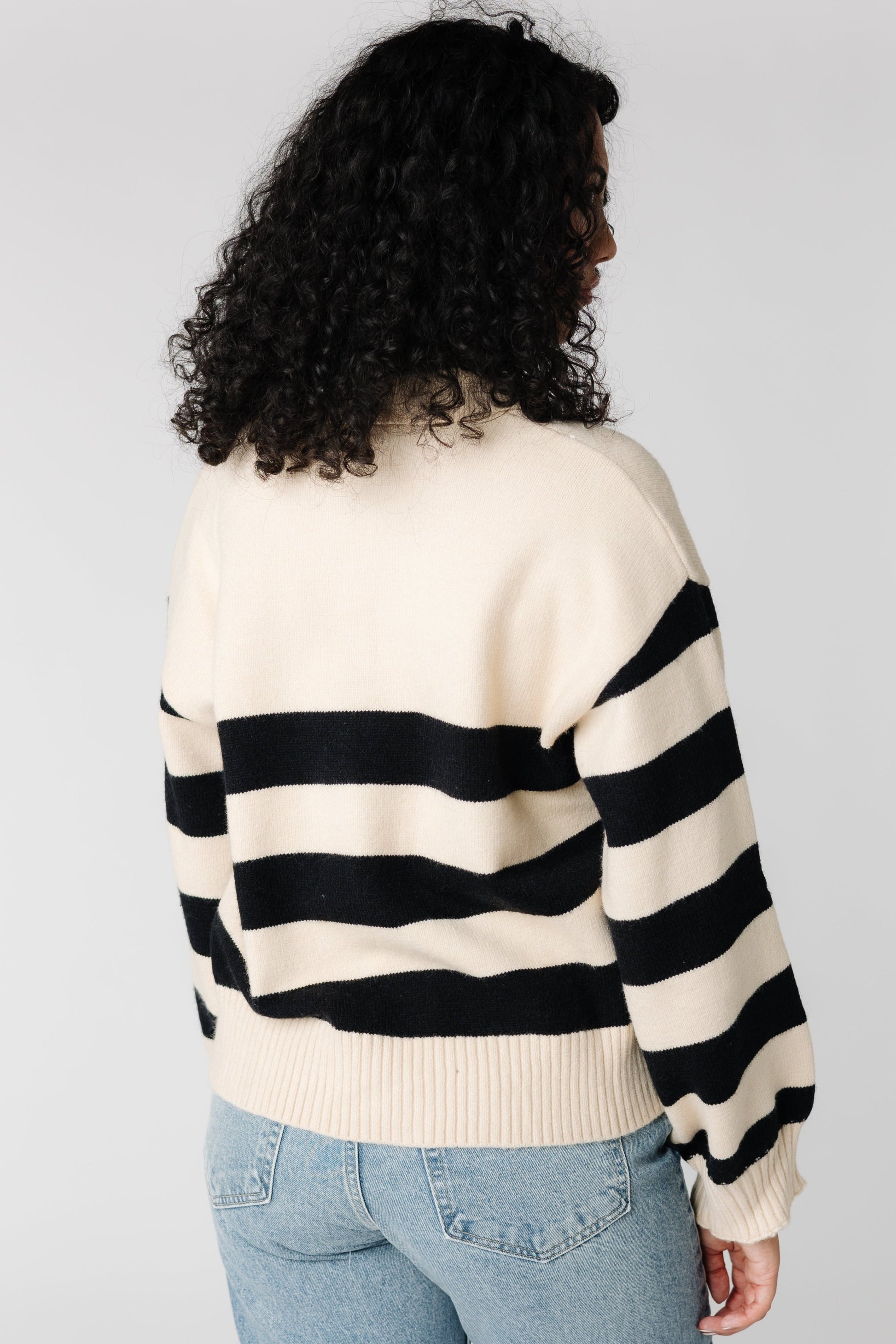 Back view of Cream and black long sleeve sweater