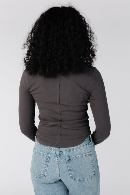 Back view of close fitting long sleeve top in charcoal