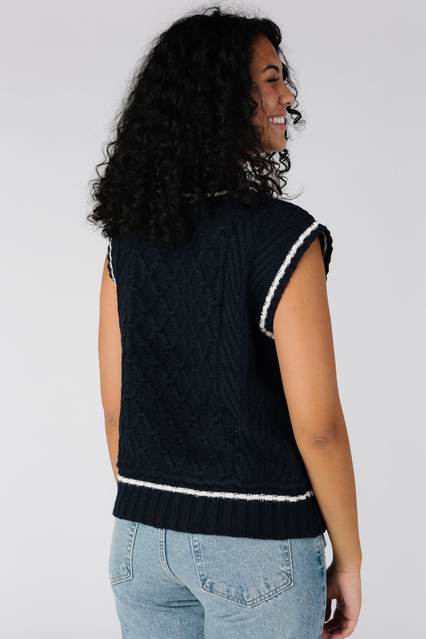 Back view of navy cabled sweater vest