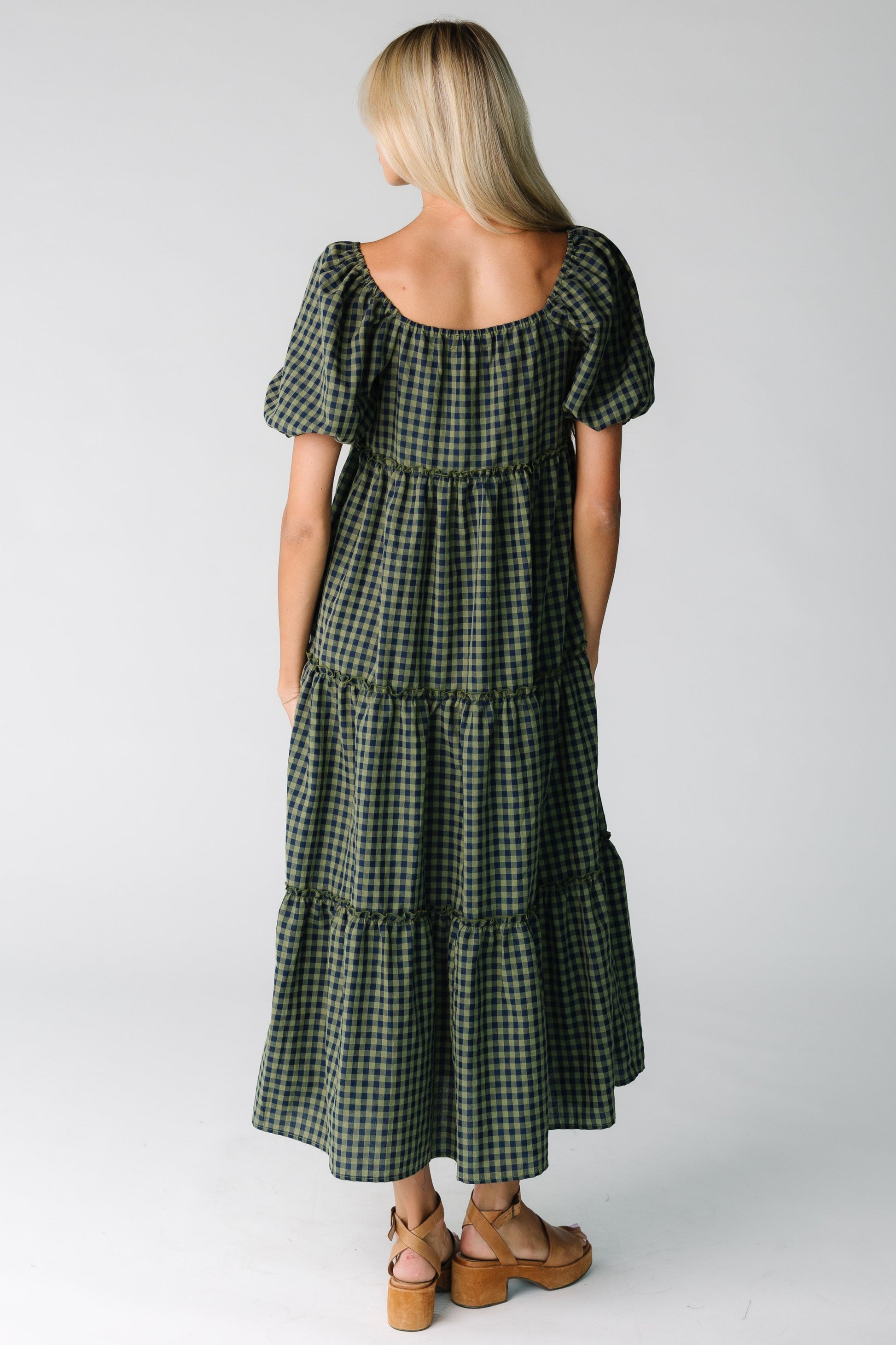 Back view of loose fitting gingham dress in green and navy