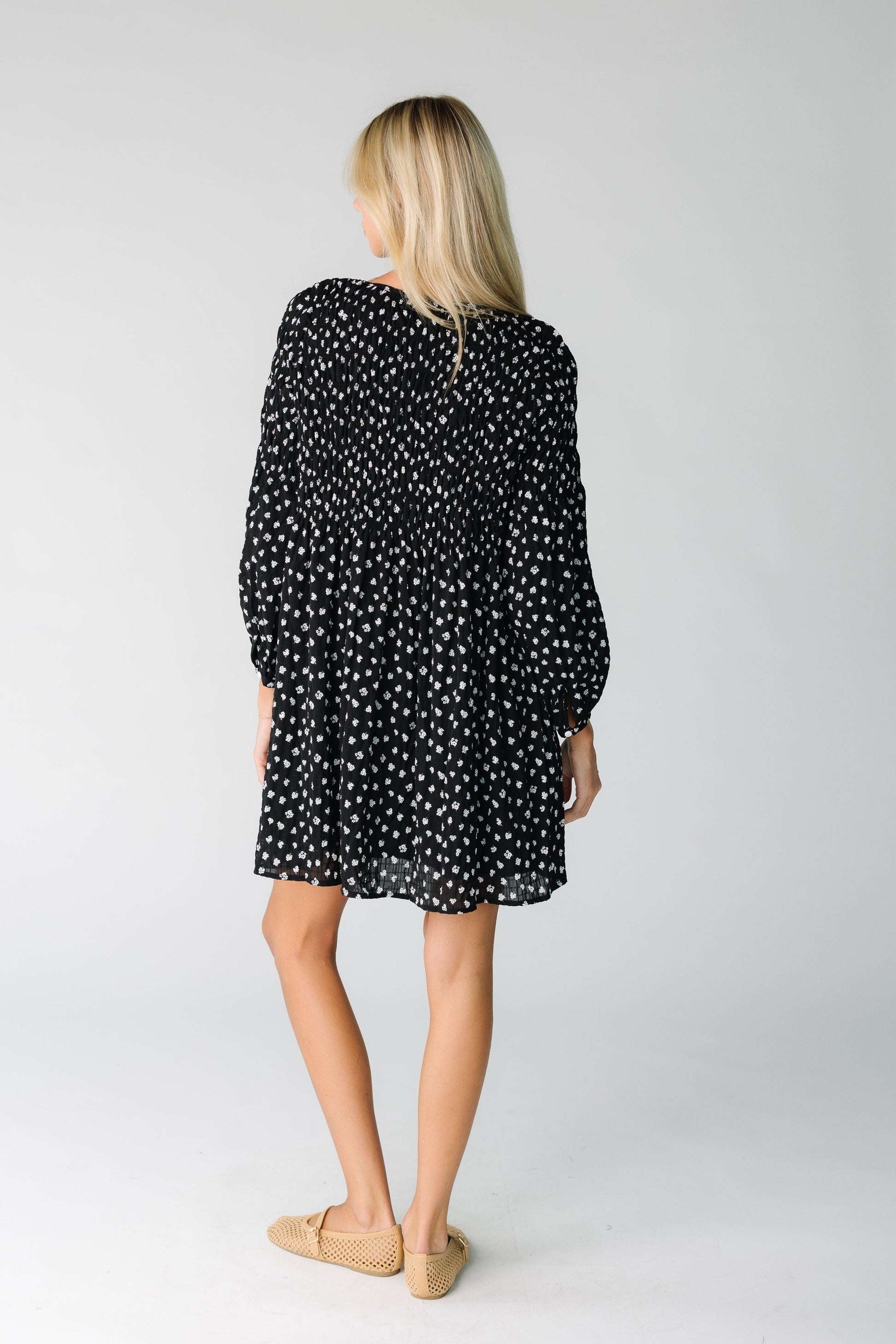 Back view of a loose fitting floral print dress