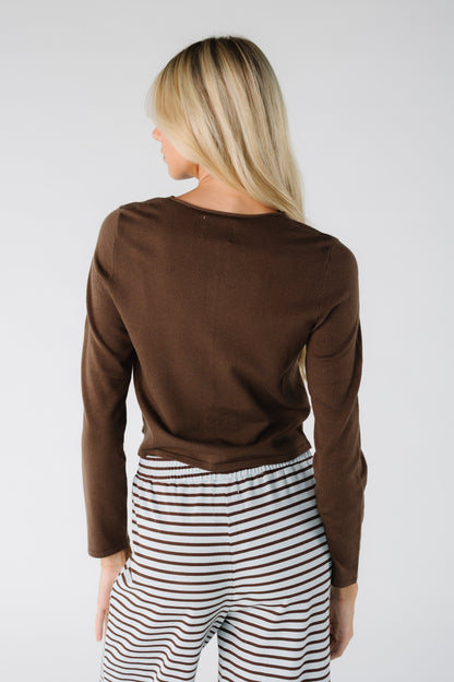 Back view of a woman wearing a brown long sleeve cardigan