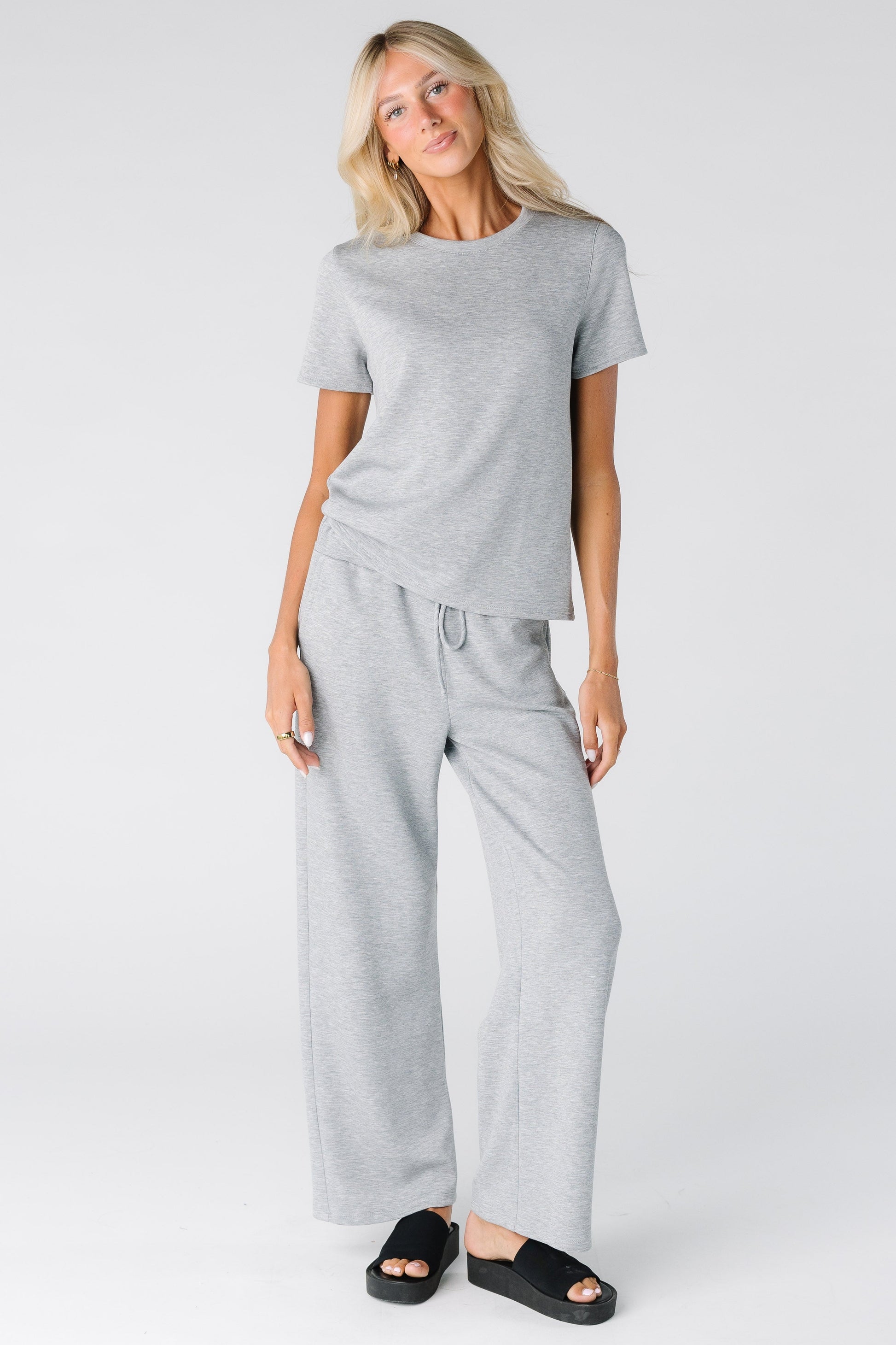 Woman wearing a modest 2 piece lounge set in light heather grey with short sleeves with full length pant