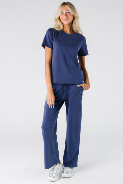 Woman wearing a blue soft 2 piece set in blue with side pockets in the pants