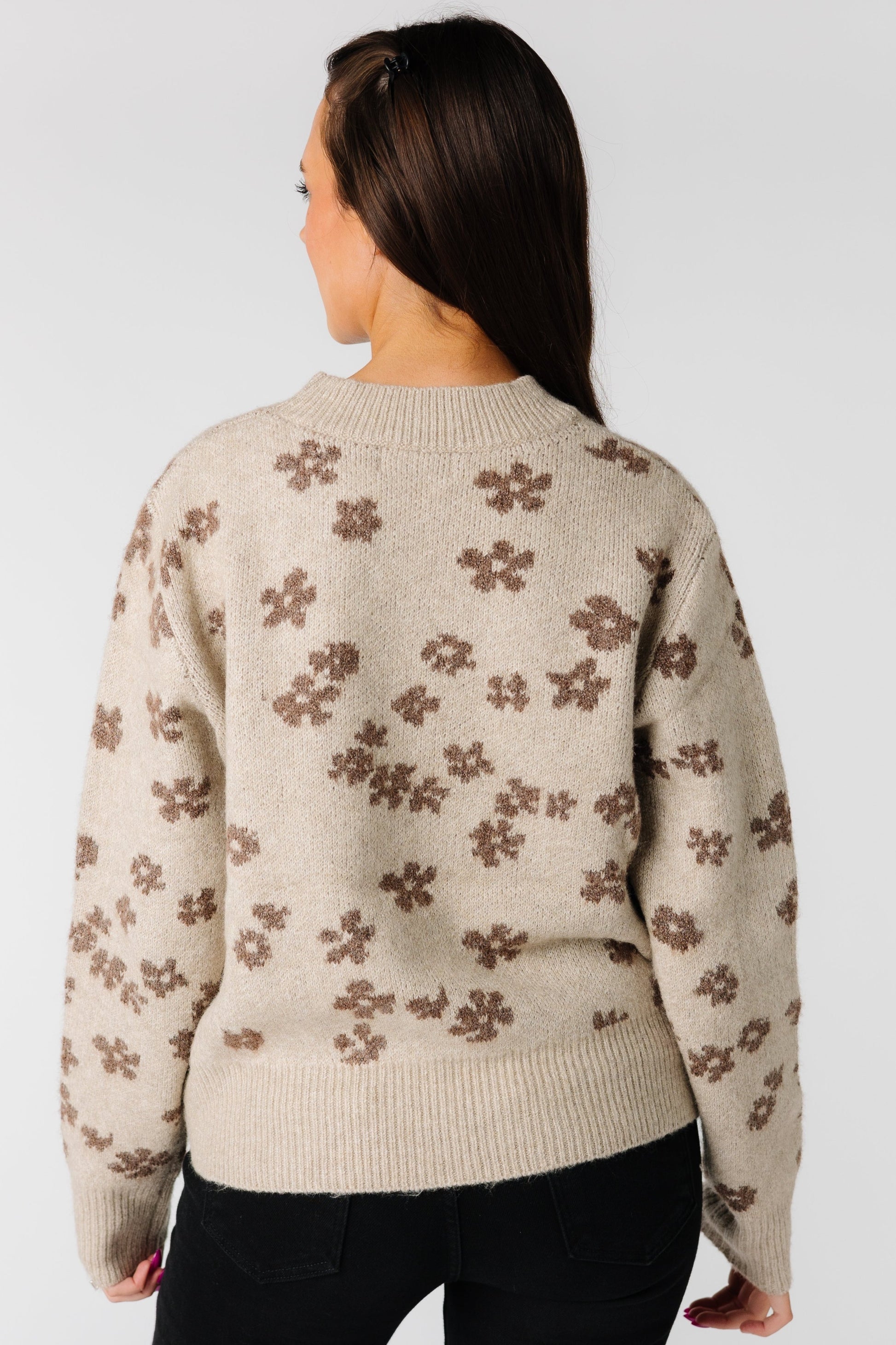 Back view of tan floral sweater