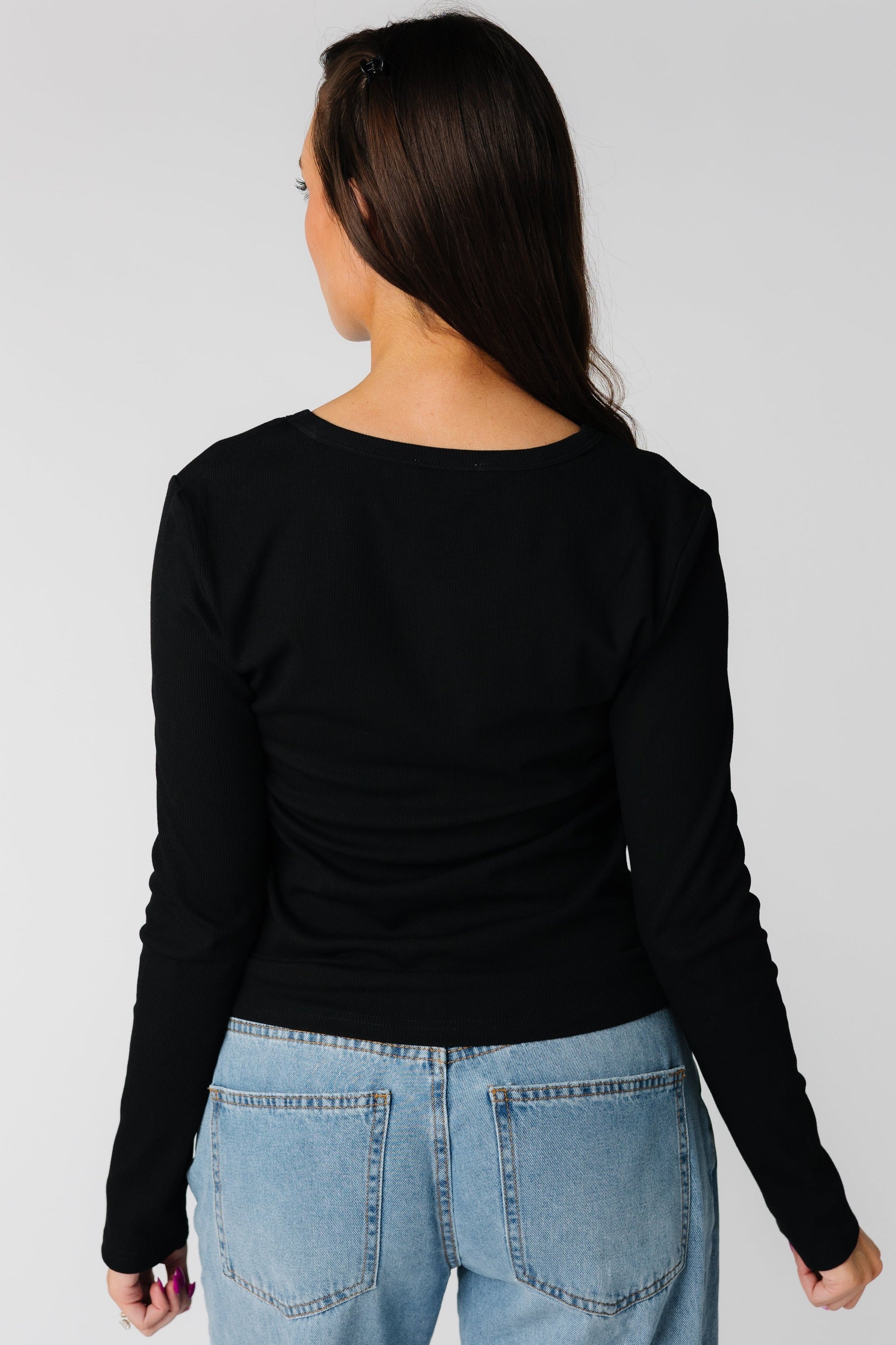 The Mills Top back view in black with long sleeves