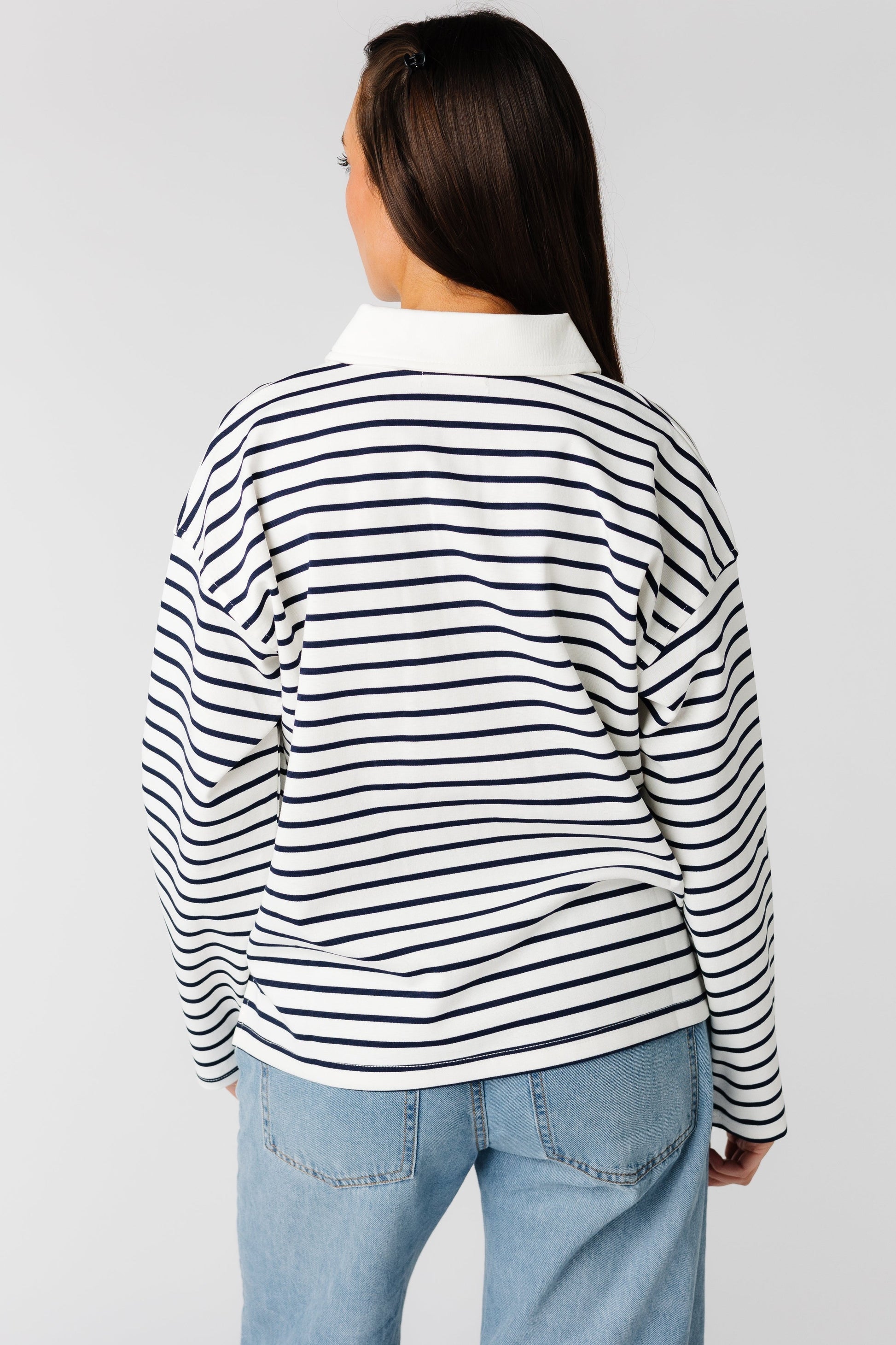 Back view of black and white stripe long sleeve top