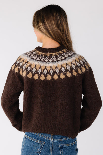 Back view of a woman wearing a brown Fair Isle cardigan