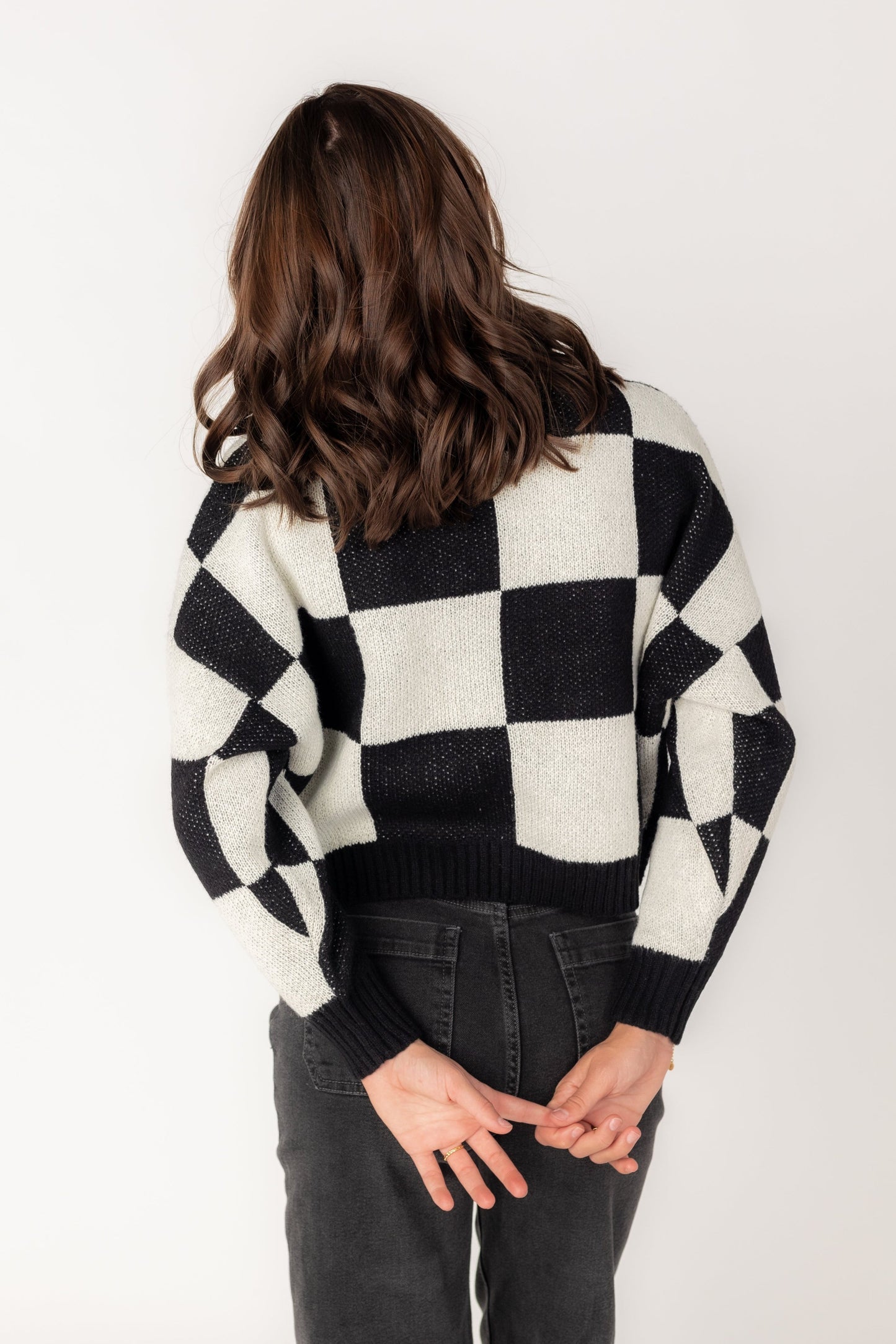 Back view of black and white checkered sweater