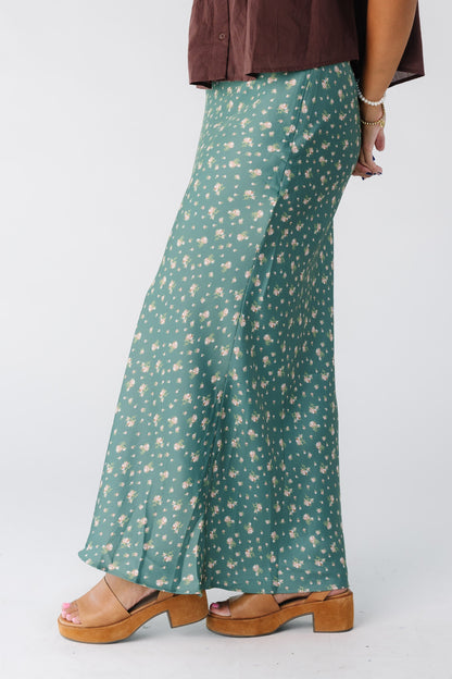 Side view of a woman wearing a green floral print maxi skirt