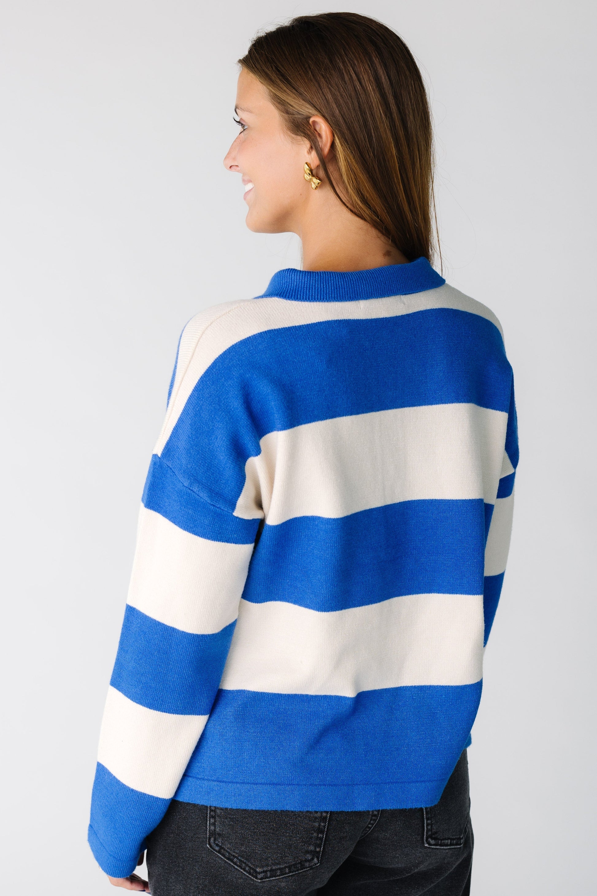 Back view of a woman wearing a blue and white stripe sweater