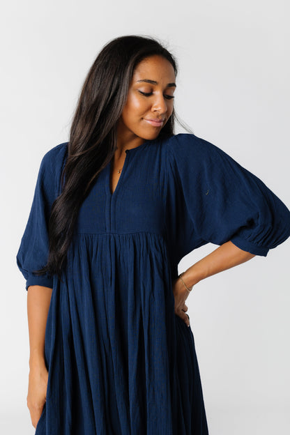 Close view of navy dress with dolman sleeves