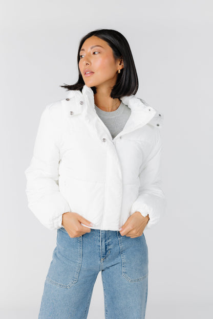 Waist length puffer jacket in white with pockets and hood