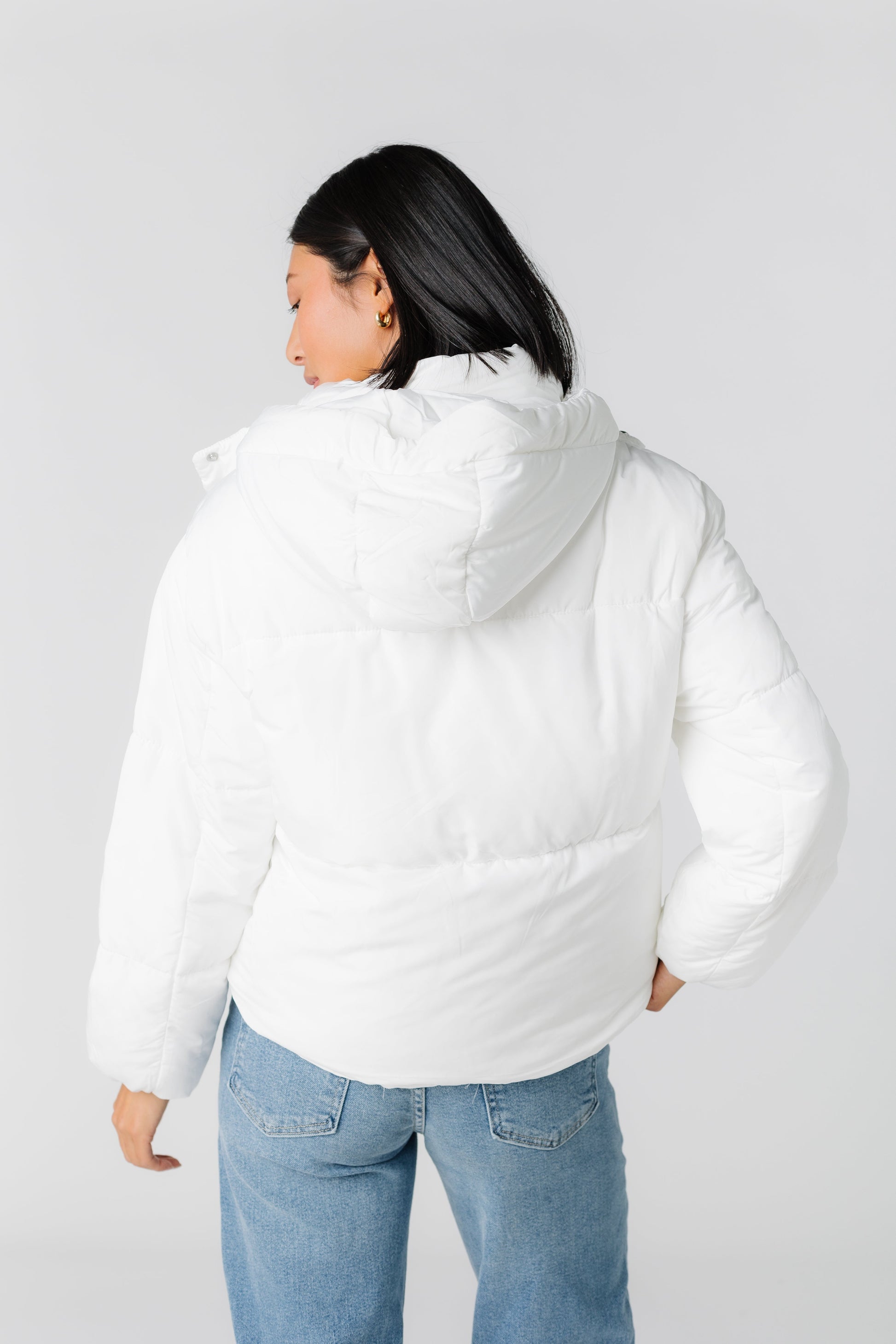 Back view of white hooded puffer jacket