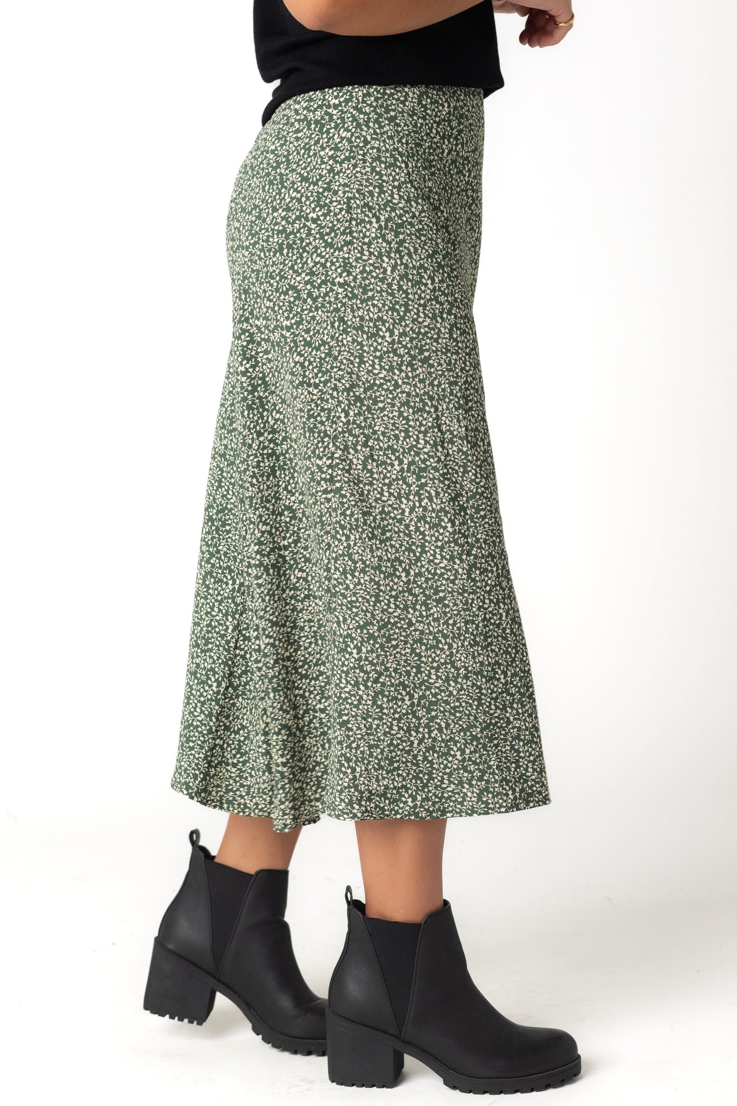 Side view of green and white print midi skirt