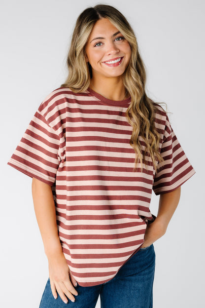 Woman wearing a modest blush stripe tee with short sleeves and crew neckline