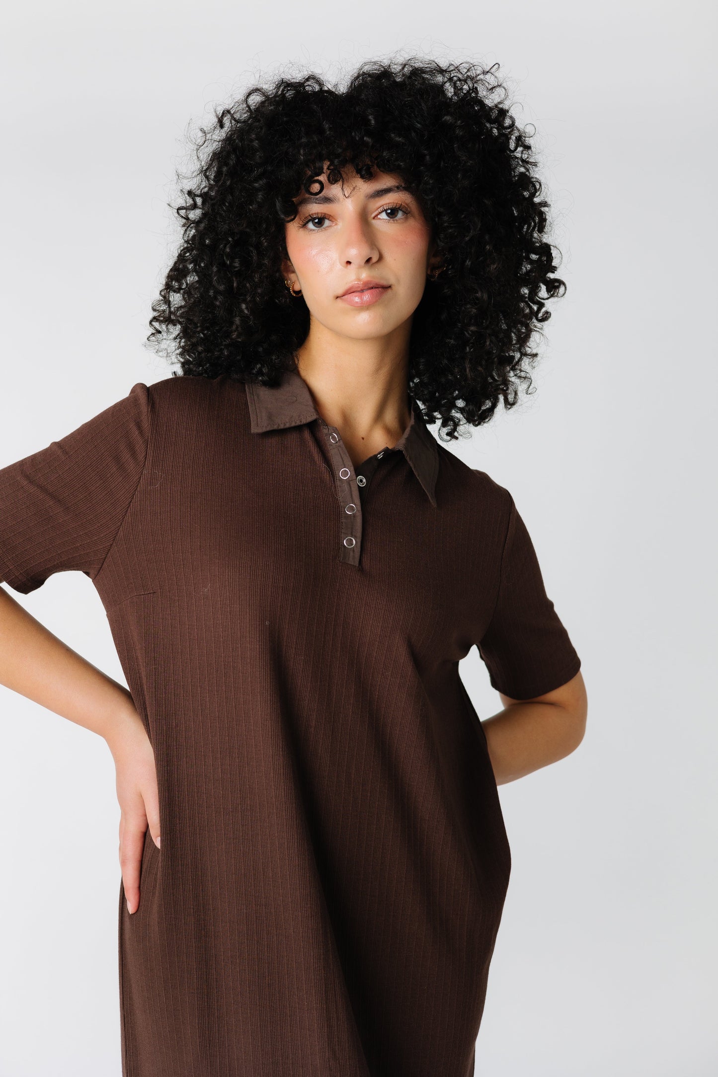 Close up view of brown knit dress and short sleeves