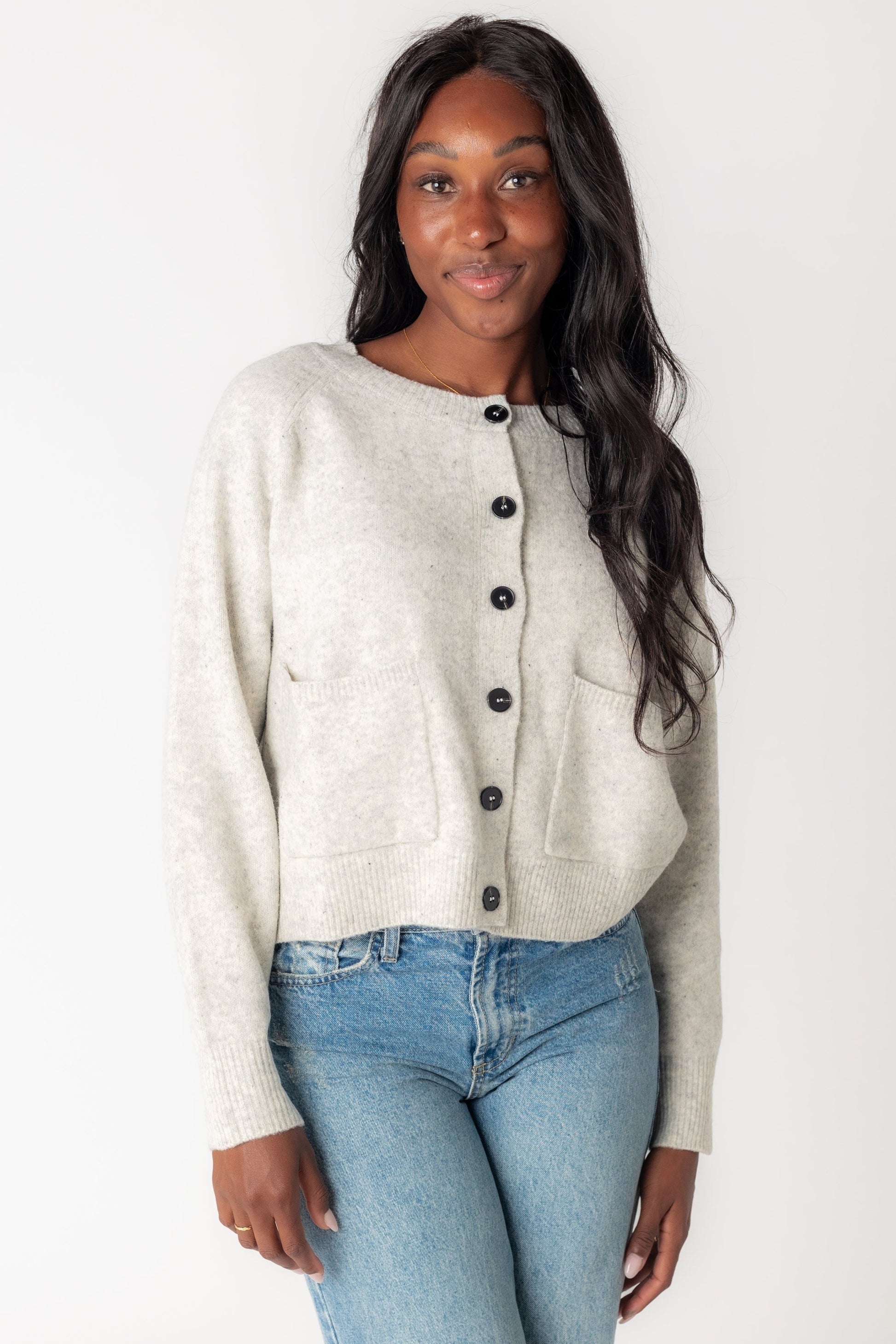 Light grey cardigan with crew neckline and long sleeves with front patch pockets