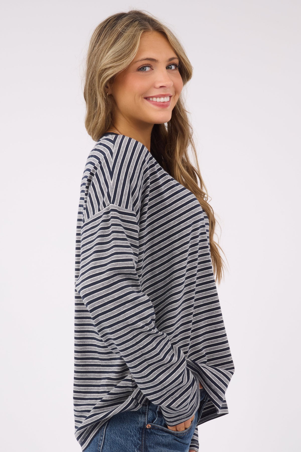 A side view of the Stripe Oversized Tee  in navy & grey stripe for women and teen girls.