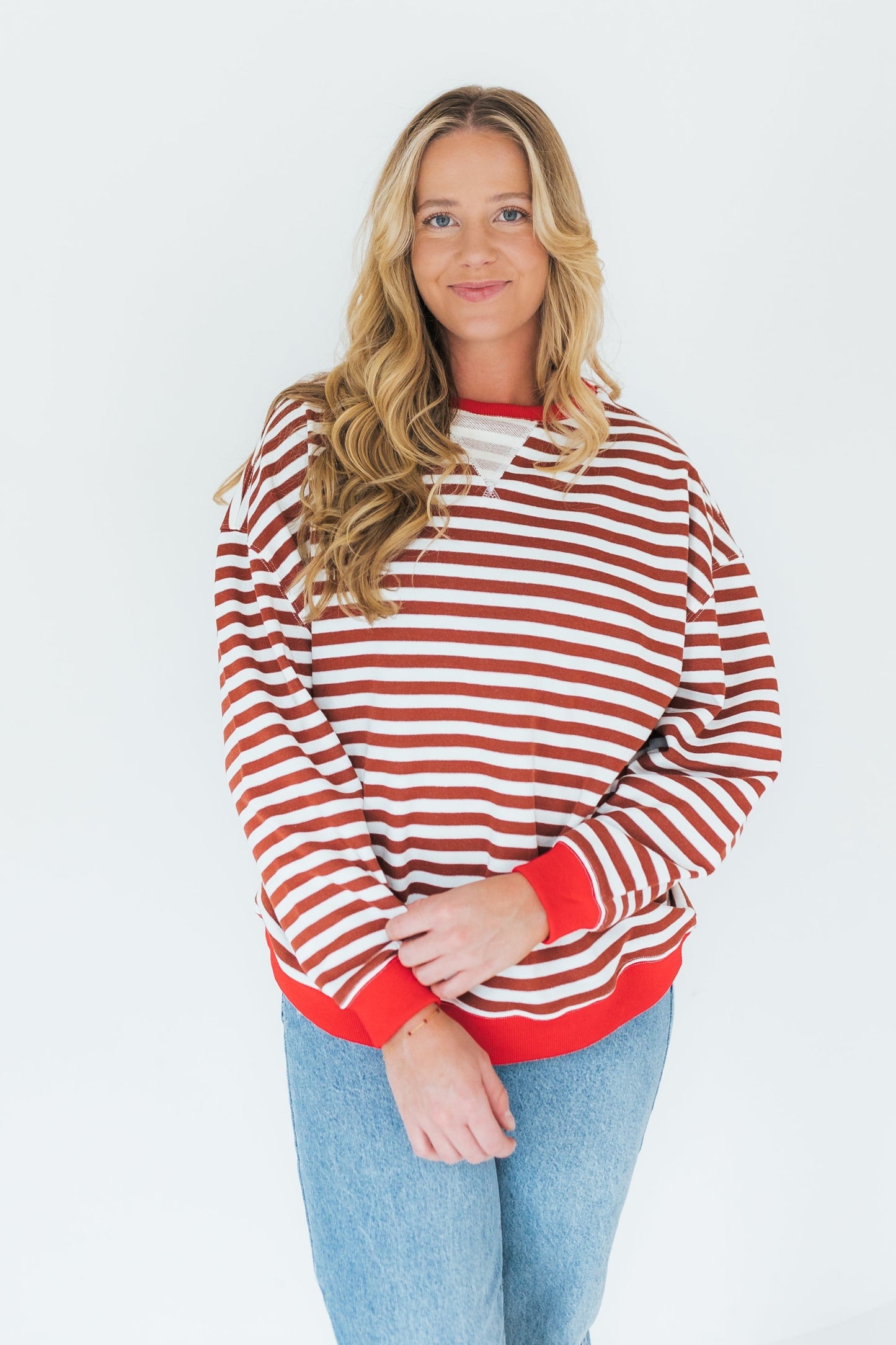 Rust and white stripe sweatshirt with crew neckline and long sleeves