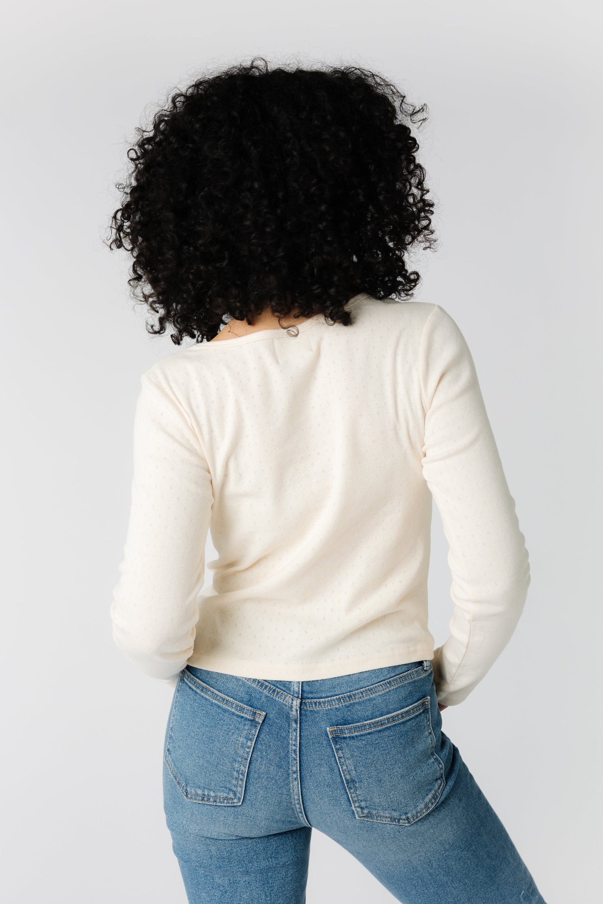 Back view of cream long sleeve knit top