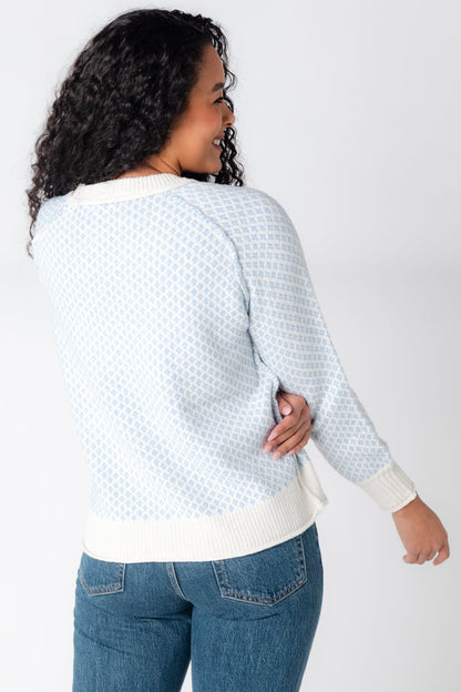 Back view of blue and white diamond pattern sweater