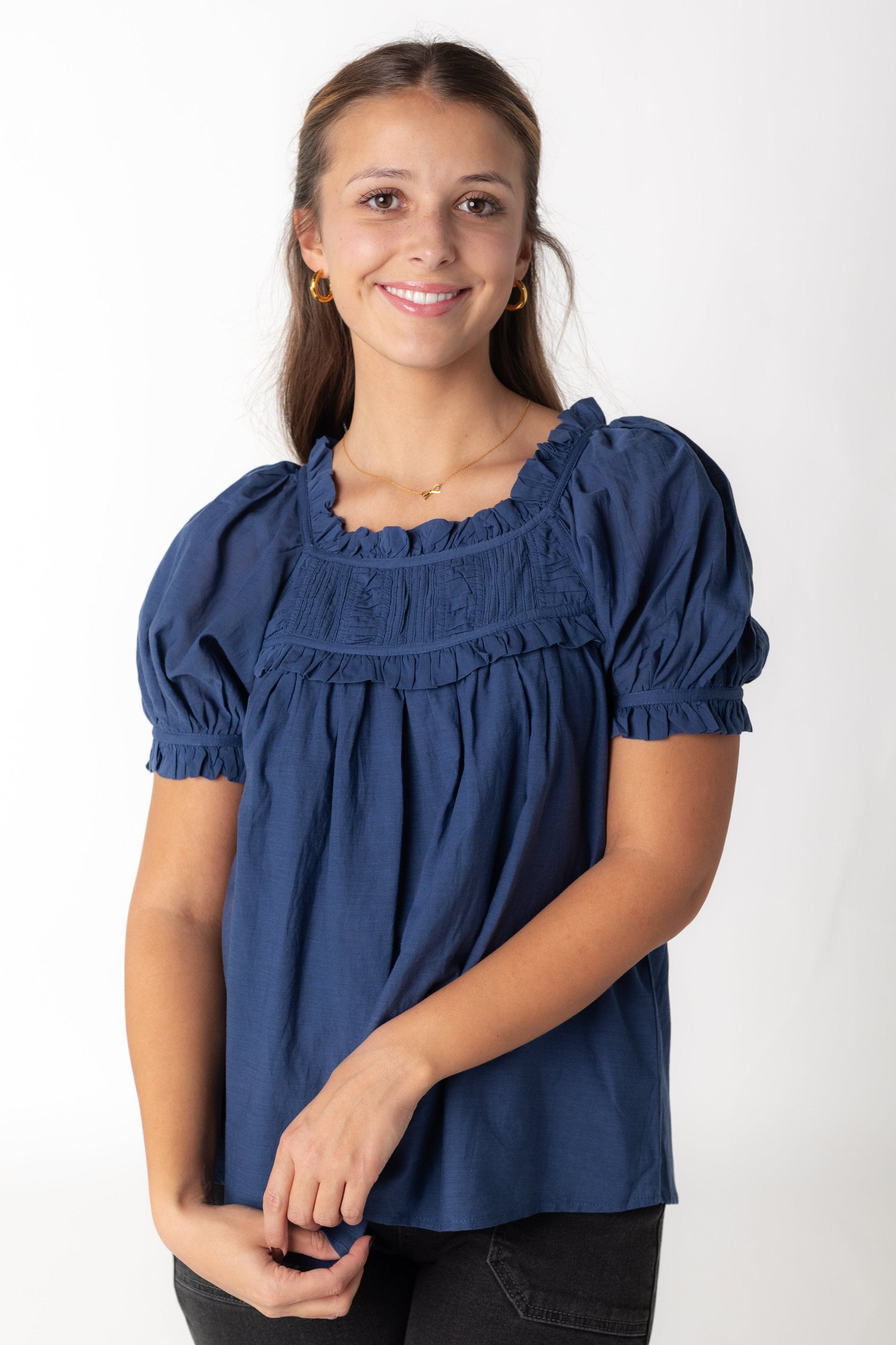 Blue woven top with ruffled scoop neckline and short puff sleeves