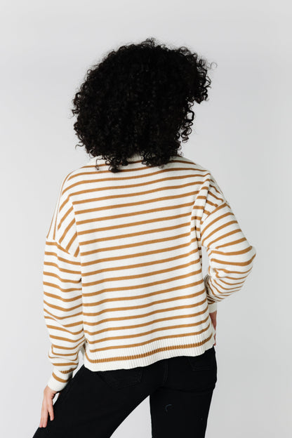 Back view of cream long sleeve sweater with cinnamon brown stripes