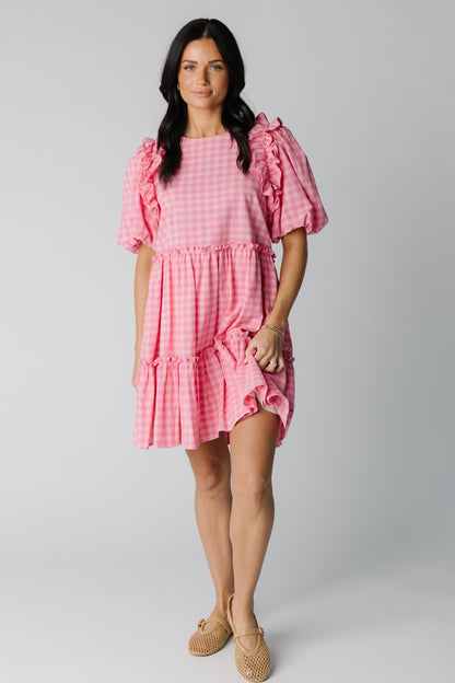 Modest pink gingham knee length dress with round neckline and half length sleeves